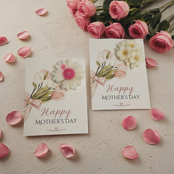 Two handmade soy wax candle cards with floral designs and "Happy Mother's Day" text surrounded by pink rose petals and roses.