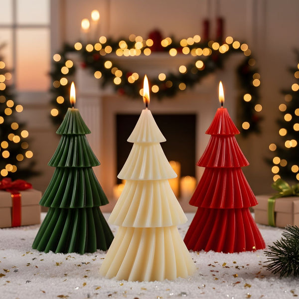 Green, white, and red Christmas tree-shaped candles with lit flames in a festive room with garlands and gifts.