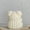 Cream-colored 3D rose teddy bear-shaped candle with textured floral surface.