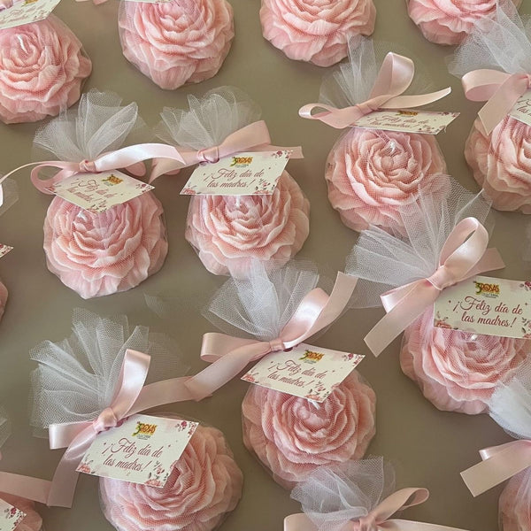 Small pink peony flower scented candles wrapped in white tulle with pink ribbon and gift tags.