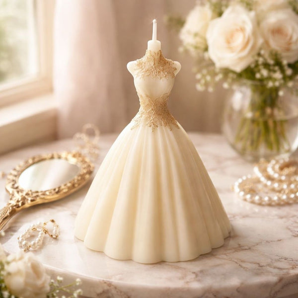 Ivory bridal gown-shaped candle with intricate bodice details, flared skirt on marble surface.