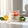 Clear glass jar candle with three rose-shaped wax wicks, labeled Citrus Bloom, surrounded by lemon slices and petals.