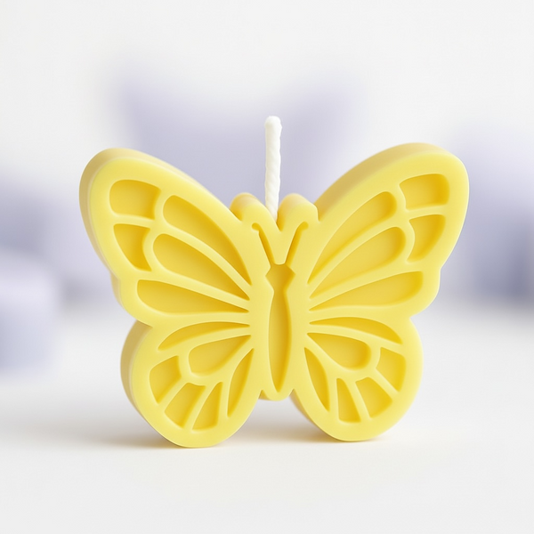Yellow butterfly-shaped candle with detailed wing patterns and a white wick center.