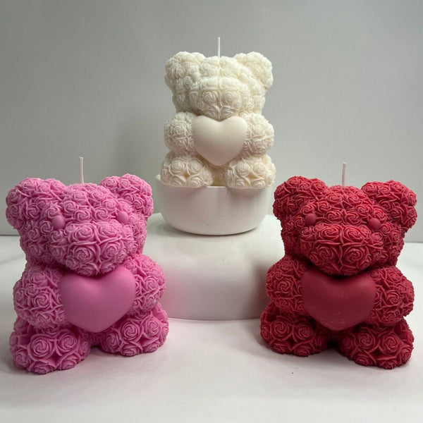 3D teddy bear candle made of intricate rose shapes holding a heart in pink, white, and red colors.