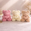 Set of three 3D teddy bear candles made of rose-shaped wax in pink, cream, and beige, each holding a heart.