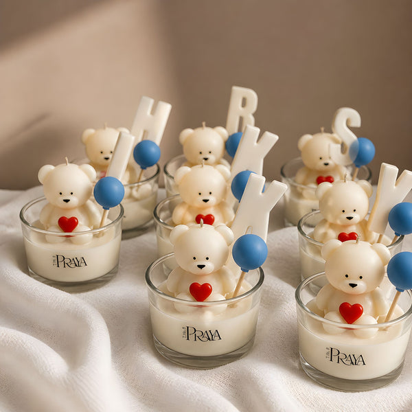 Candle holders with teddy bears, hearts, and letters on a white surface