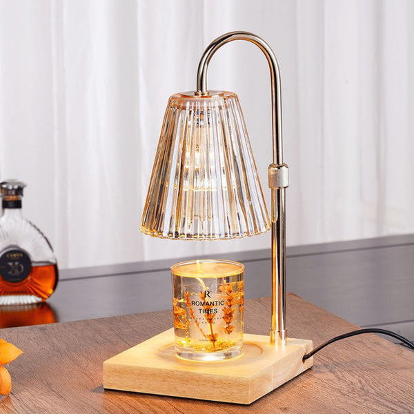 Electronic candle warmer lamp with ribbed amber glass shade on wooden base.