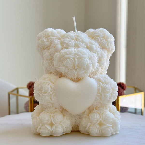 White 3D teddy bear candle made of rose-shaped wax with a heart on its chest.